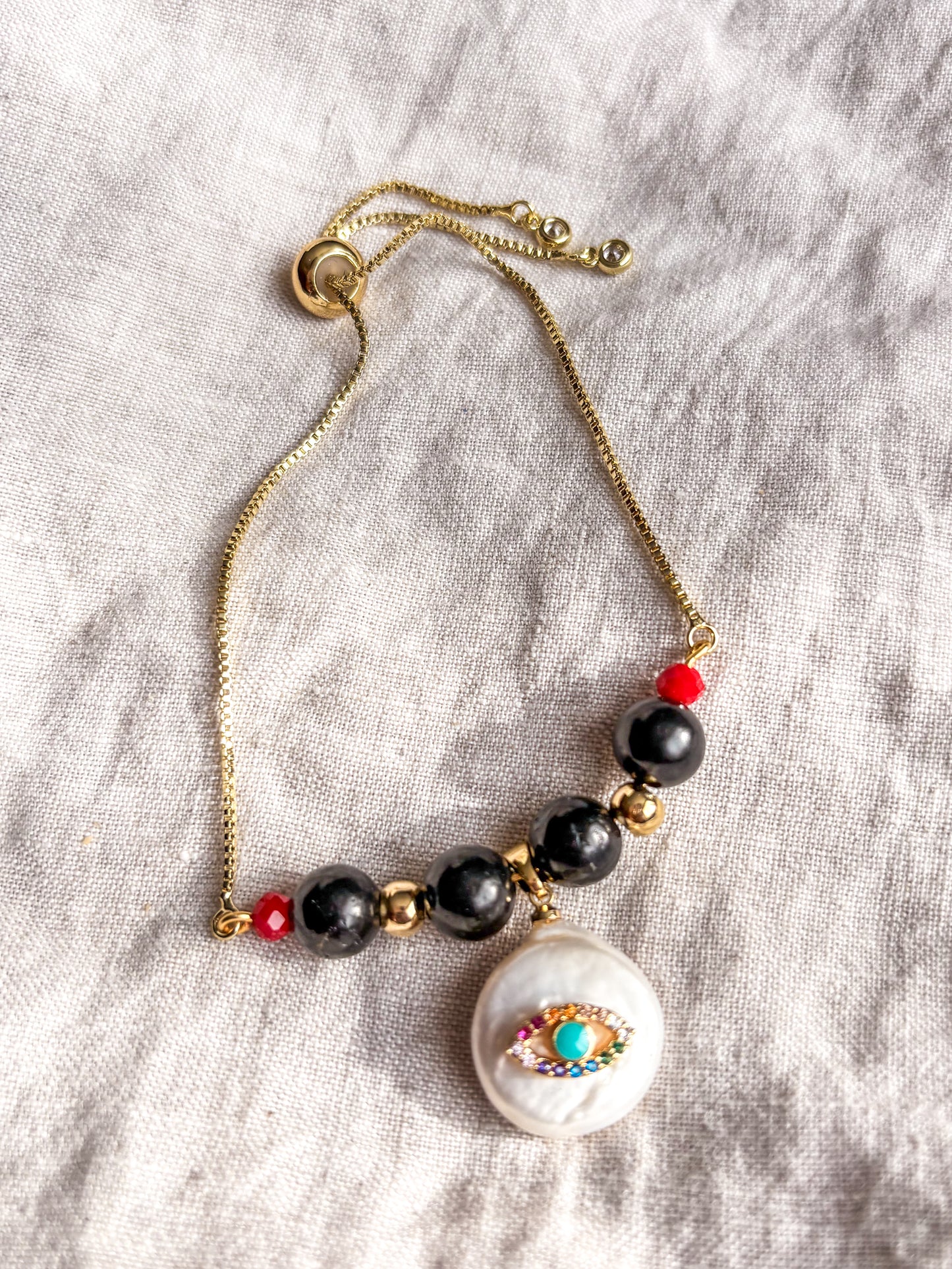 Pulsera Amuleto Ojo Turco Protector: Shunguita y Nácar Natural